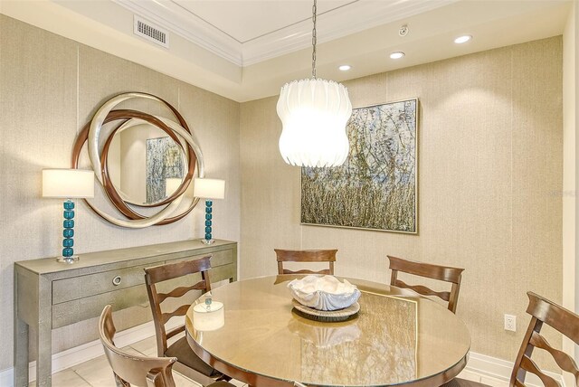 dining space featuring light tile floors and crown molding