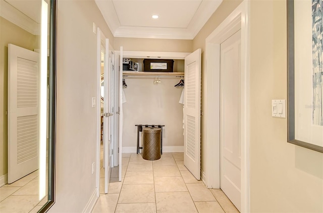 hall featuring light tile flooring and crown molding