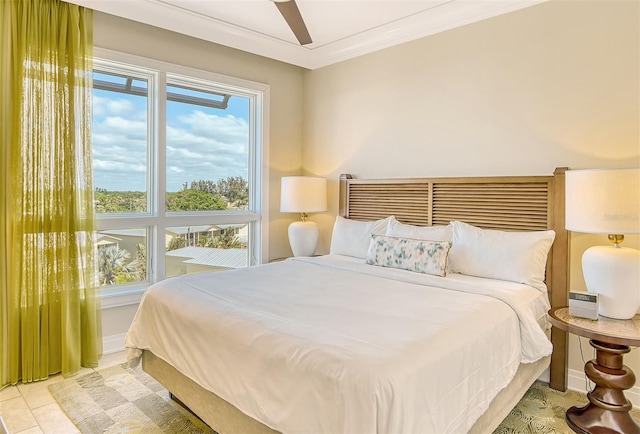 bedroom with light tile floors, ornamental molding, and ceiling fan