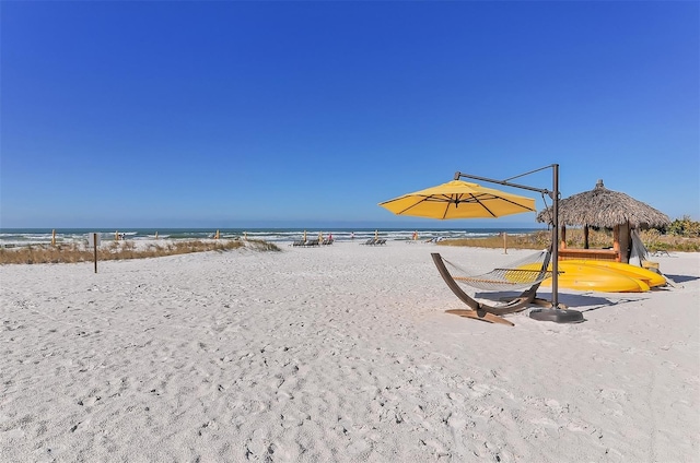 property view of water featuring a gazebo and a beach view