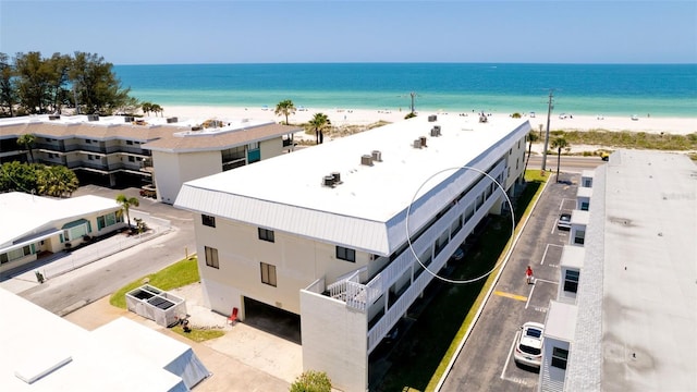 exterior space featuring a beach view and a water view