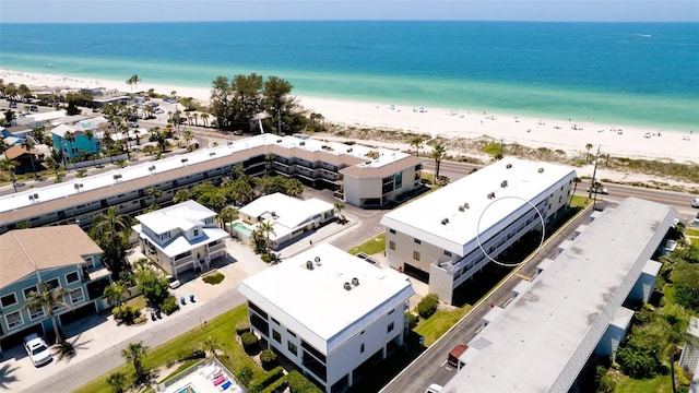 drone / aerial view featuring a water view and a beach view