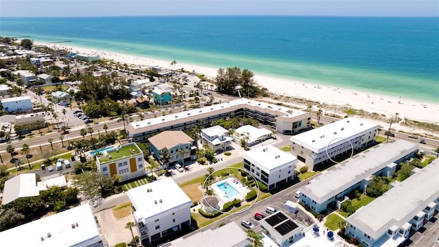 birds eye view of property with a beach view and a water view