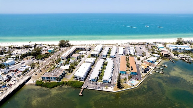 bird's eye view featuring a water view and a beach view