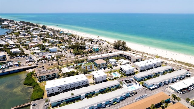 birds eye view of property featuring a beach view and a water view