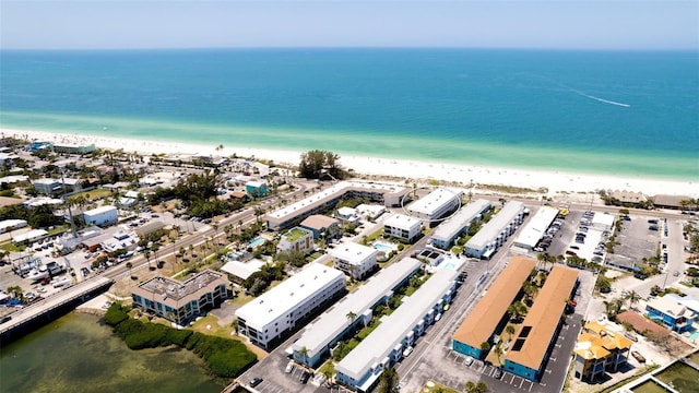 drone / aerial view with a beach view and a water view