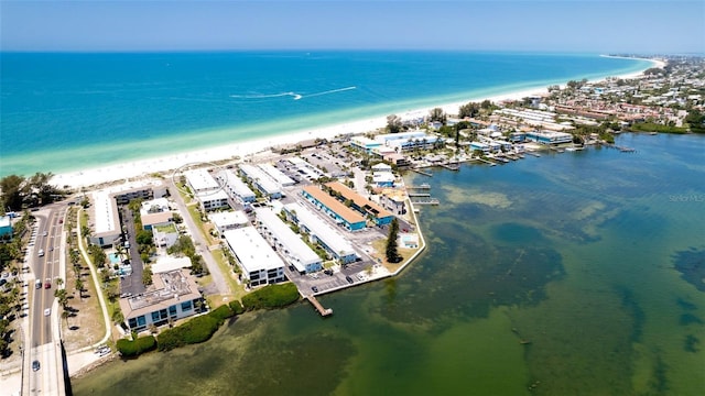 drone / aerial view featuring a beach view and a water view