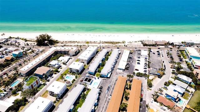 bird's eye view featuring a water view and a beach view