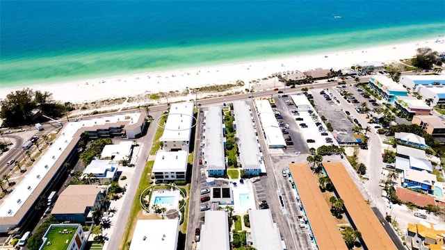 birds eye view of property with a beach view and a water view