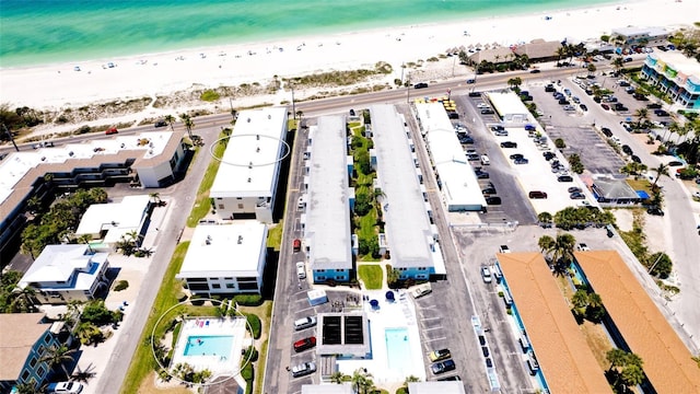 drone / aerial view featuring a water view and a beach view