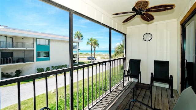 balcony with a water view and ceiling fan