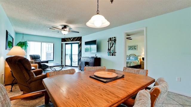 dining room featuring a textured ceiling, light tile flooring, and ceiling fan