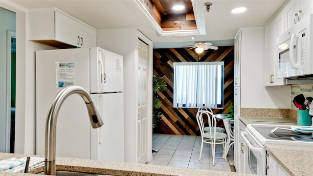 kitchen featuring ceiling fan, white appliances, and white cabinetry