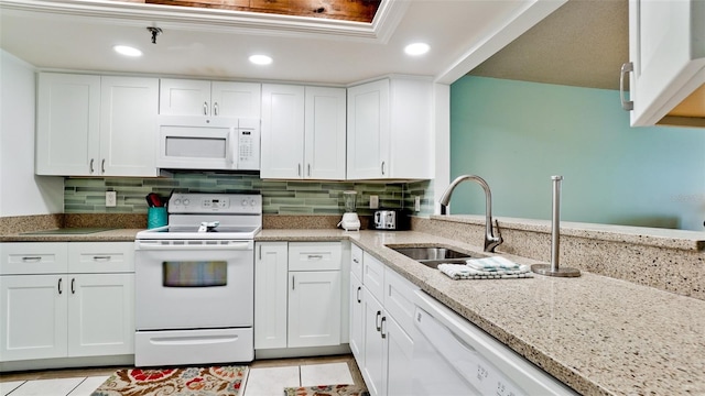 kitchen with white cabinets, tasteful backsplash, white appliances, and sink