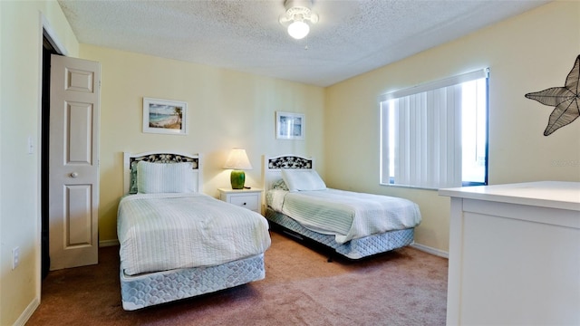 bedroom with carpet and a textured ceiling