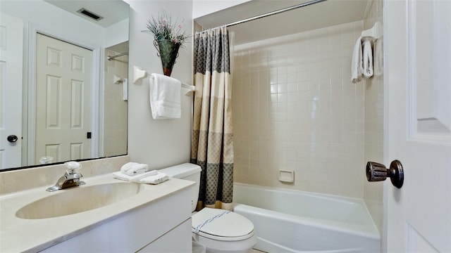 full bathroom with shower / bath combo, toilet, and vanity with extensive cabinet space