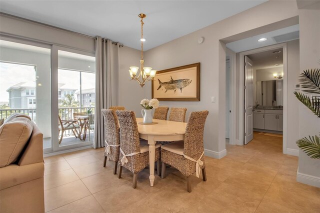 tiled dining space with a notable chandelier