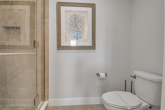 bathroom with tile patterned floors, toilet, and a shower with door