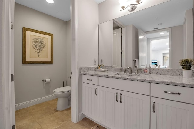 bathroom with tile patterned floors, vanity, and toilet