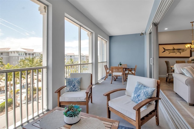 sunroom featuring a notable chandelier