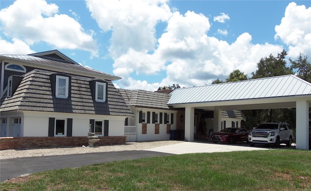 exterior space with a carport and a front yard