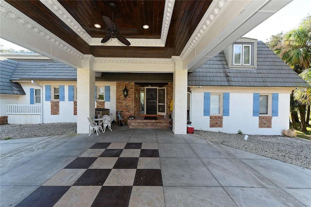 exterior space with ceiling fan and a patio area