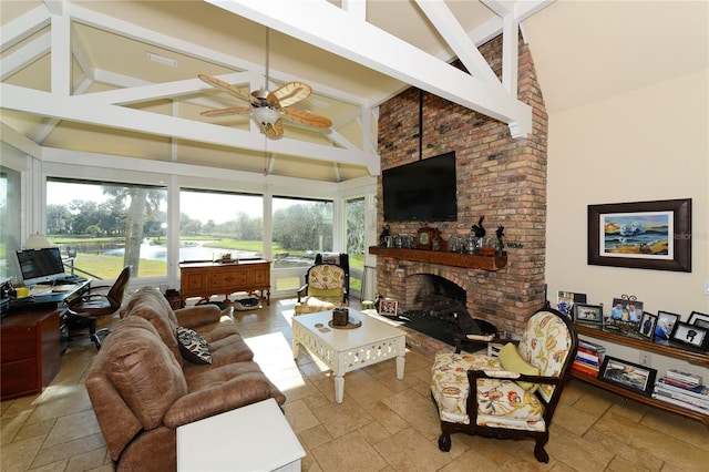 living room with ceiling fan, plenty of natural light, beam ceiling, and high vaulted ceiling