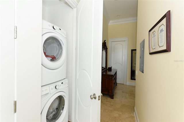 laundry area with electric panel, ornamental molding, and stacked washer / drying machine