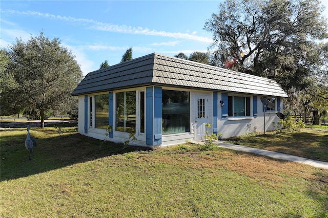 rear view of house featuring a yard