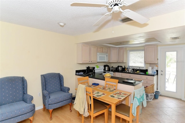 kitchen with ceiling fan, sink, stainless steel range with electric stovetop, light tile patterned floors, and a textured ceiling