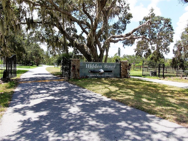 community sign featuring a yard