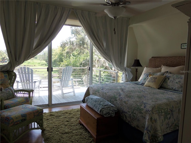 bedroom with access to exterior, hardwood / wood-style flooring, and ceiling fan