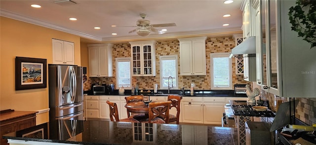 kitchen with ornamental molding, white cabinets, and stainless steel fridge with ice dispenser