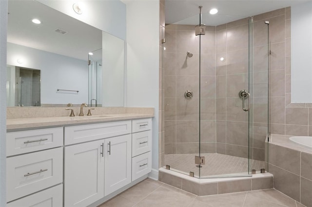 bathroom featuring tile patterned flooring, vanity, and independent shower and bath