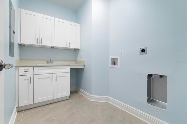 clothes washing area featuring sink, cabinets, washer hookup, electric dryer hookup, and light tile patterned floors