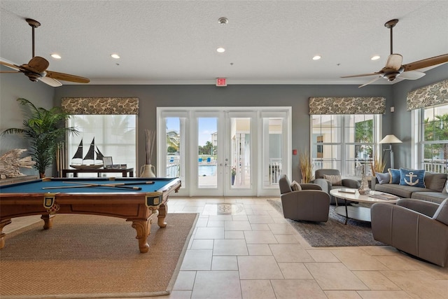 playroom featuring light tile patterned floors, a textured ceiling, a healthy amount of sunlight, and billiards