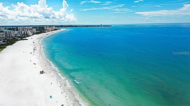 drone / aerial view with a water view and a beach view