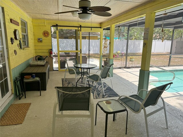 sunroom / solarium featuring ceiling fan