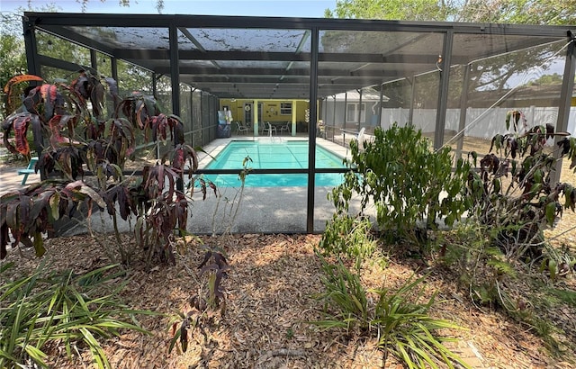 view of pool with glass enclosure