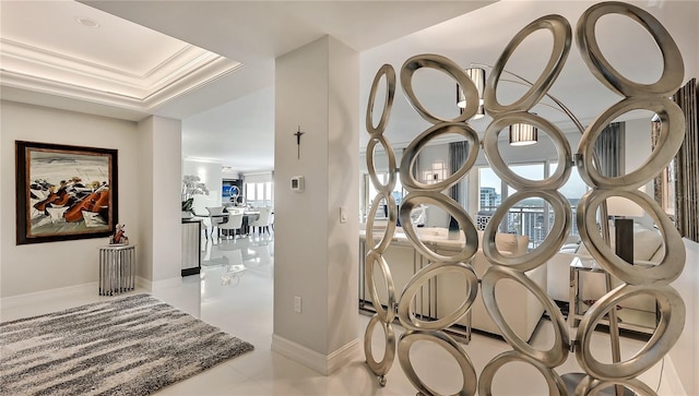 details with a raised ceiling, ornamental molding, and light tile floors