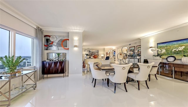 tiled dining area featuring ornamental molding