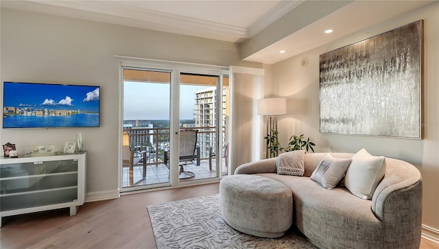 living area with ornamental molding and light wood-type flooring