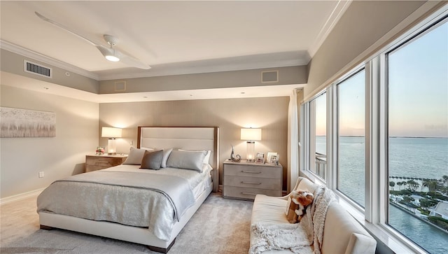 carpeted bedroom featuring ornamental molding, ceiling fan, and a water view