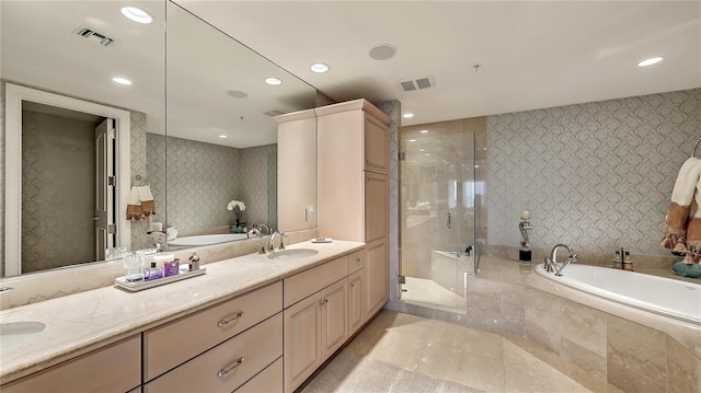 bathroom with tile floors, double vanity, and separate shower and tub