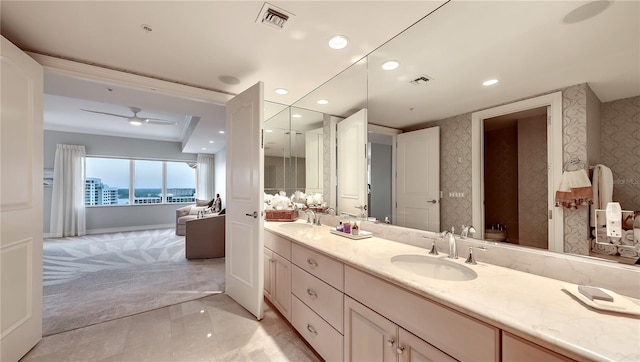 bathroom with double sink, ceiling fan, tile flooring, and vanity with extensive cabinet space