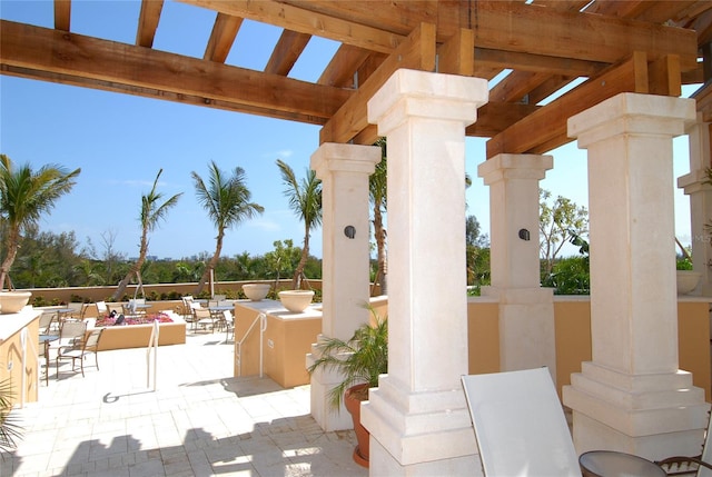 view of patio featuring a pergola, exterior bar, and exterior kitchen