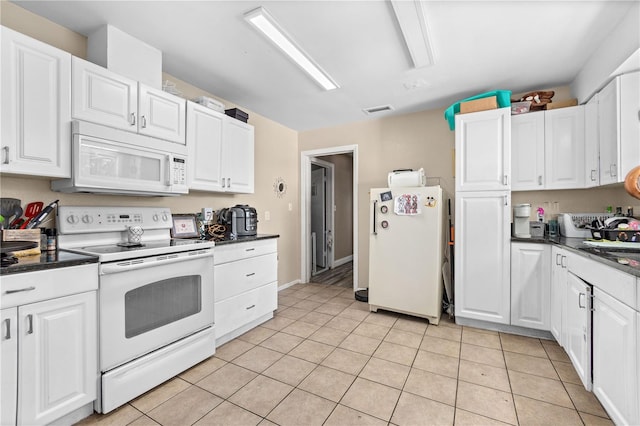 kitchen featuring white cabinetry, white appliances, and light tile patterned flooring