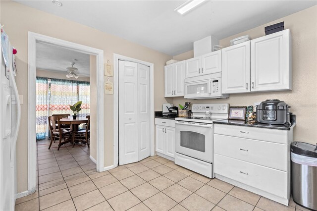 kitchen featuring white cabinetry, white appliances, and light tile patterned flooring