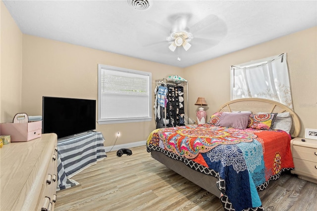 bedroom with ceiling fan and light hardwood / wood-style floors