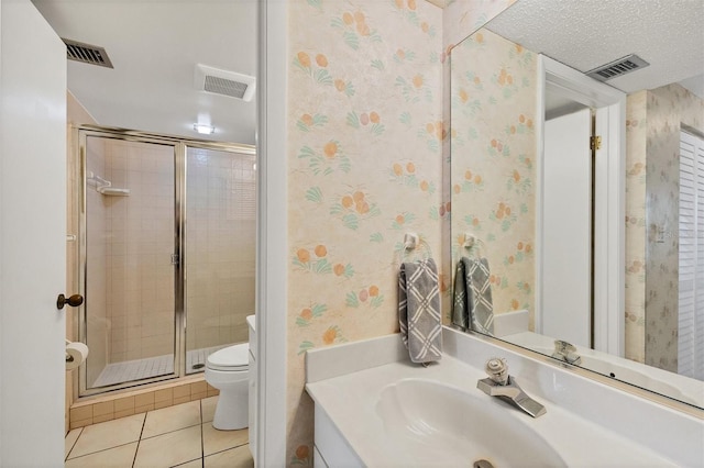 bathroom with tile patterned floors, a textured ceiling, toilet, vanity, and a shower with shower door